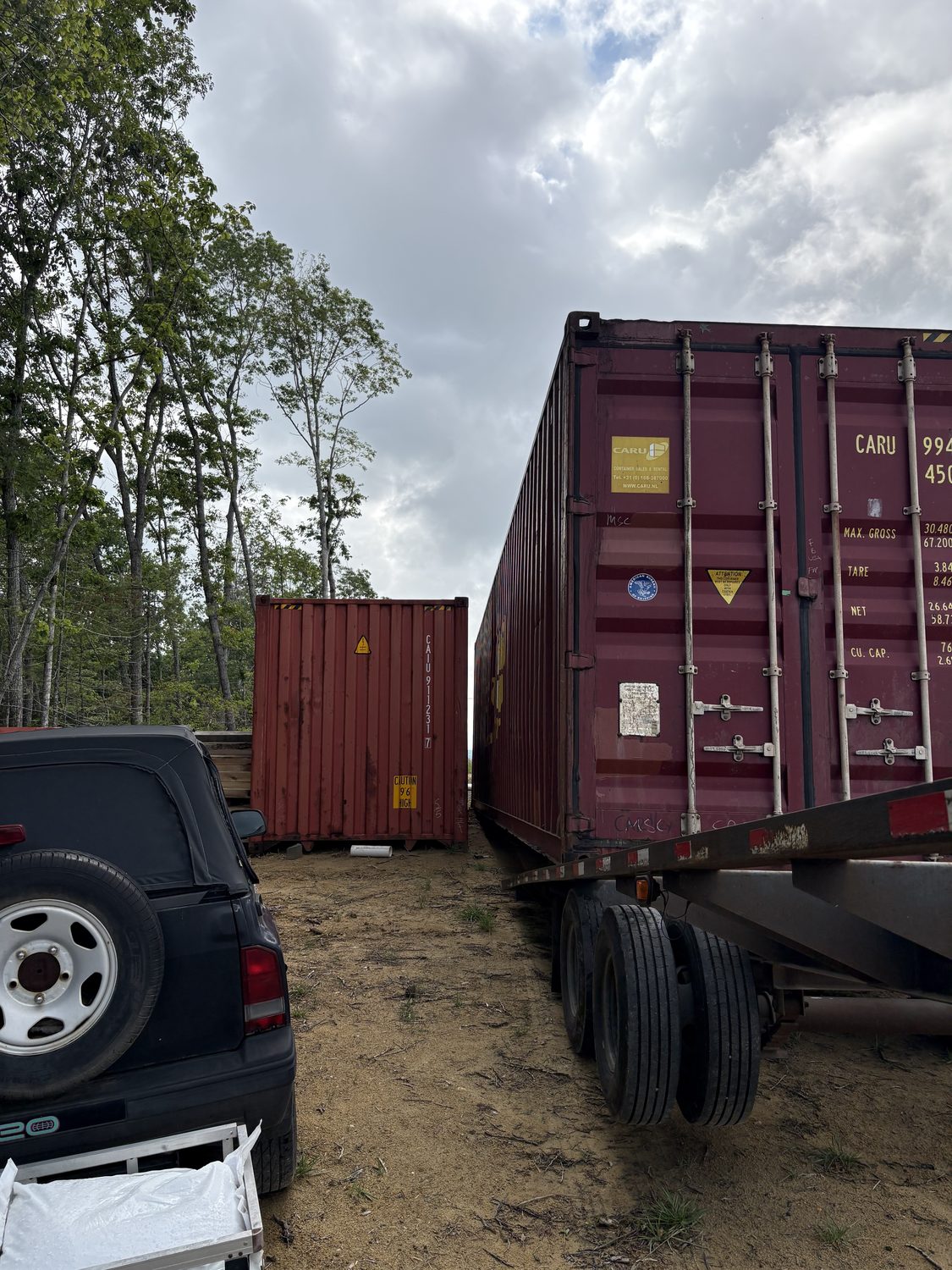 One-trip container being delivered and leveled on foundation blocks